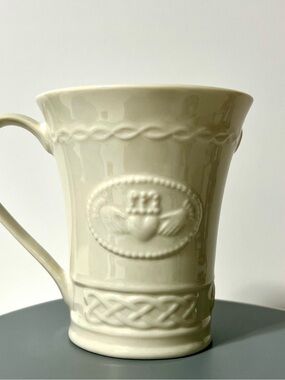 Belleek Cream Ceramic Mug with Embossed Claddagh and Celtic Band